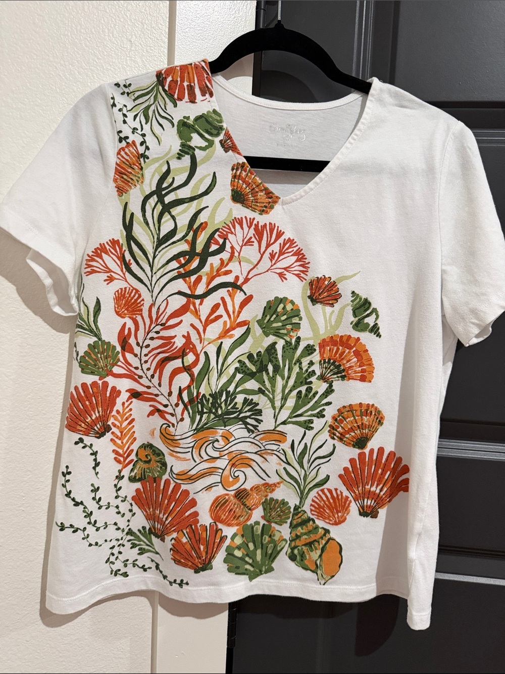 Coral Bay White V-Neck Tee with Orange and Green Shell Motif